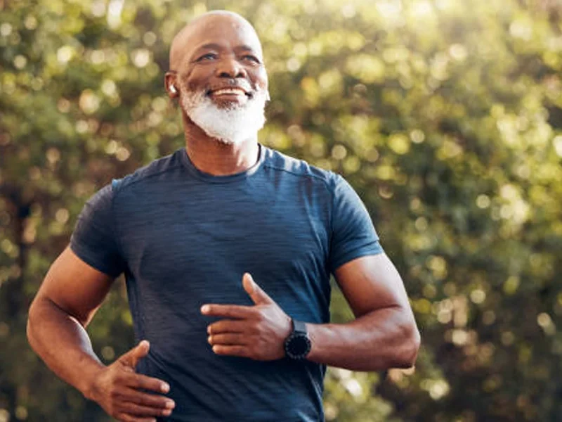 Older man running outdoors, staying active and energetic